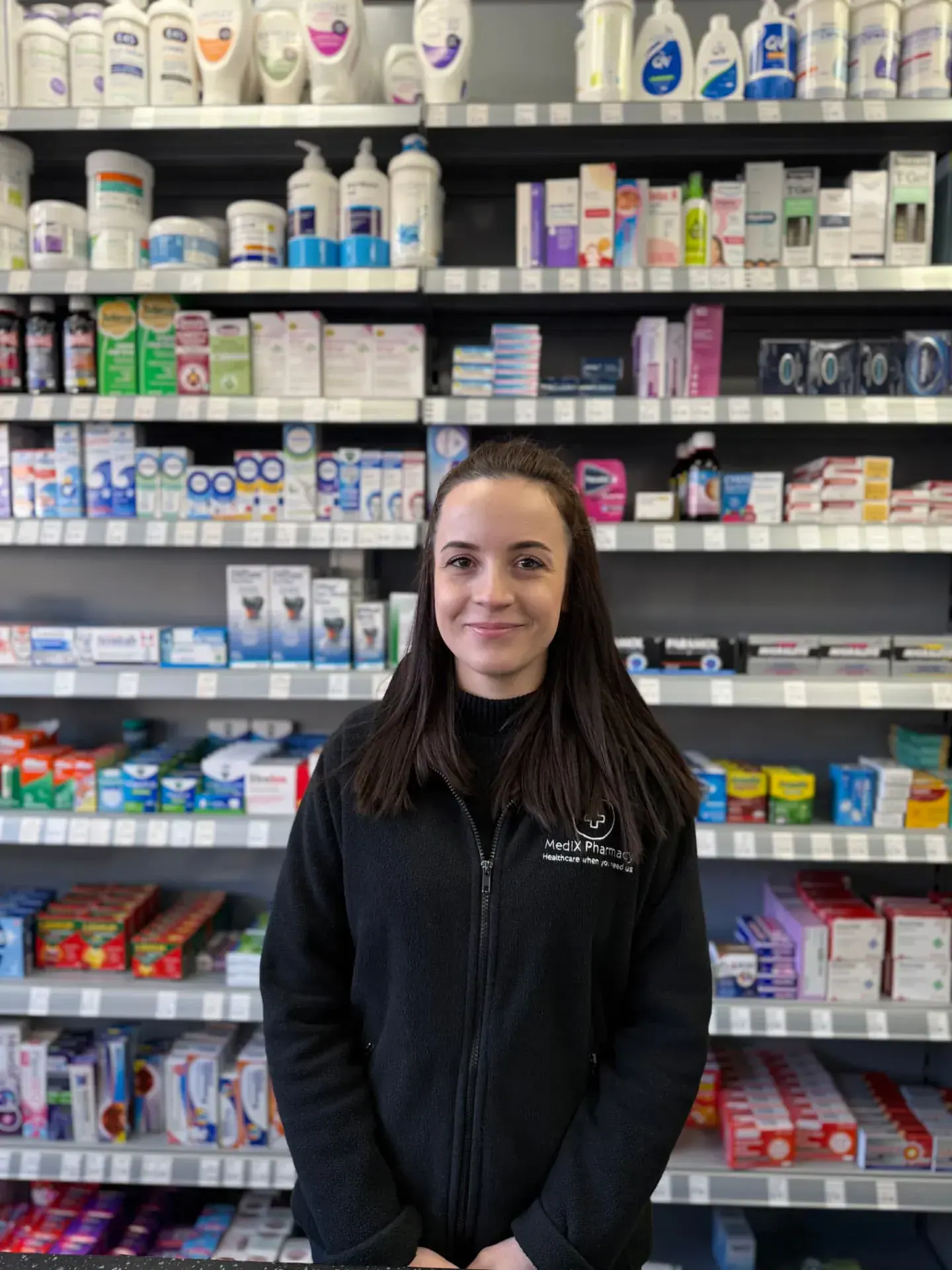 Member of the Medix Pharmacy team behind the counter