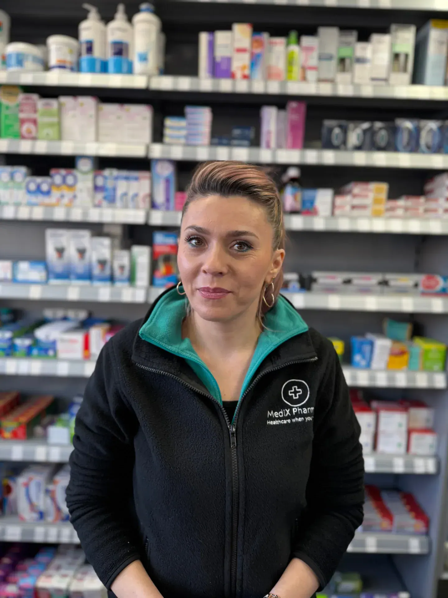 Member of the Medix Pharmacy team behind the counter