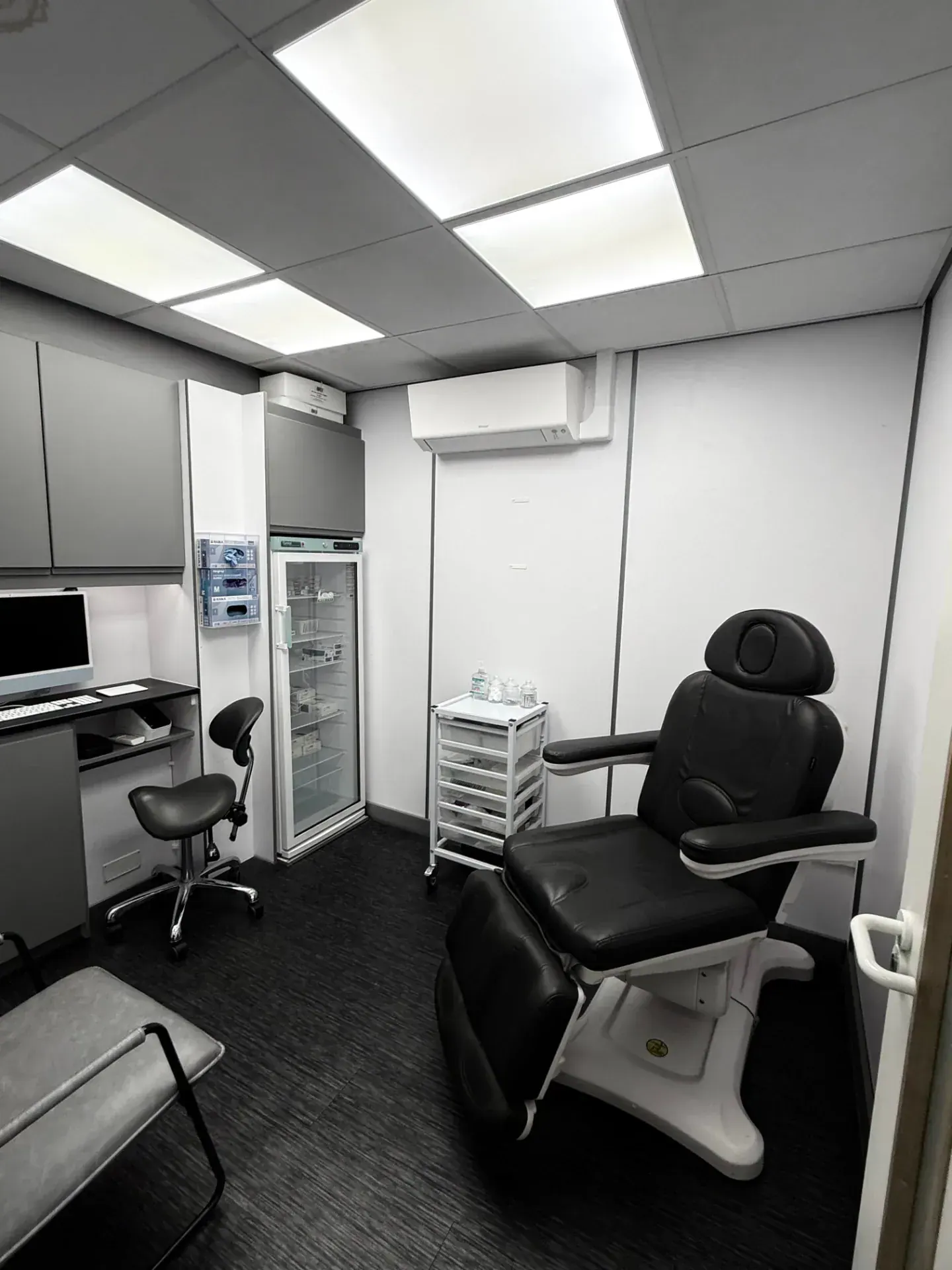 The private clinic room at Medix Pharmacy with a phlebotomy chair and refrigerated storage